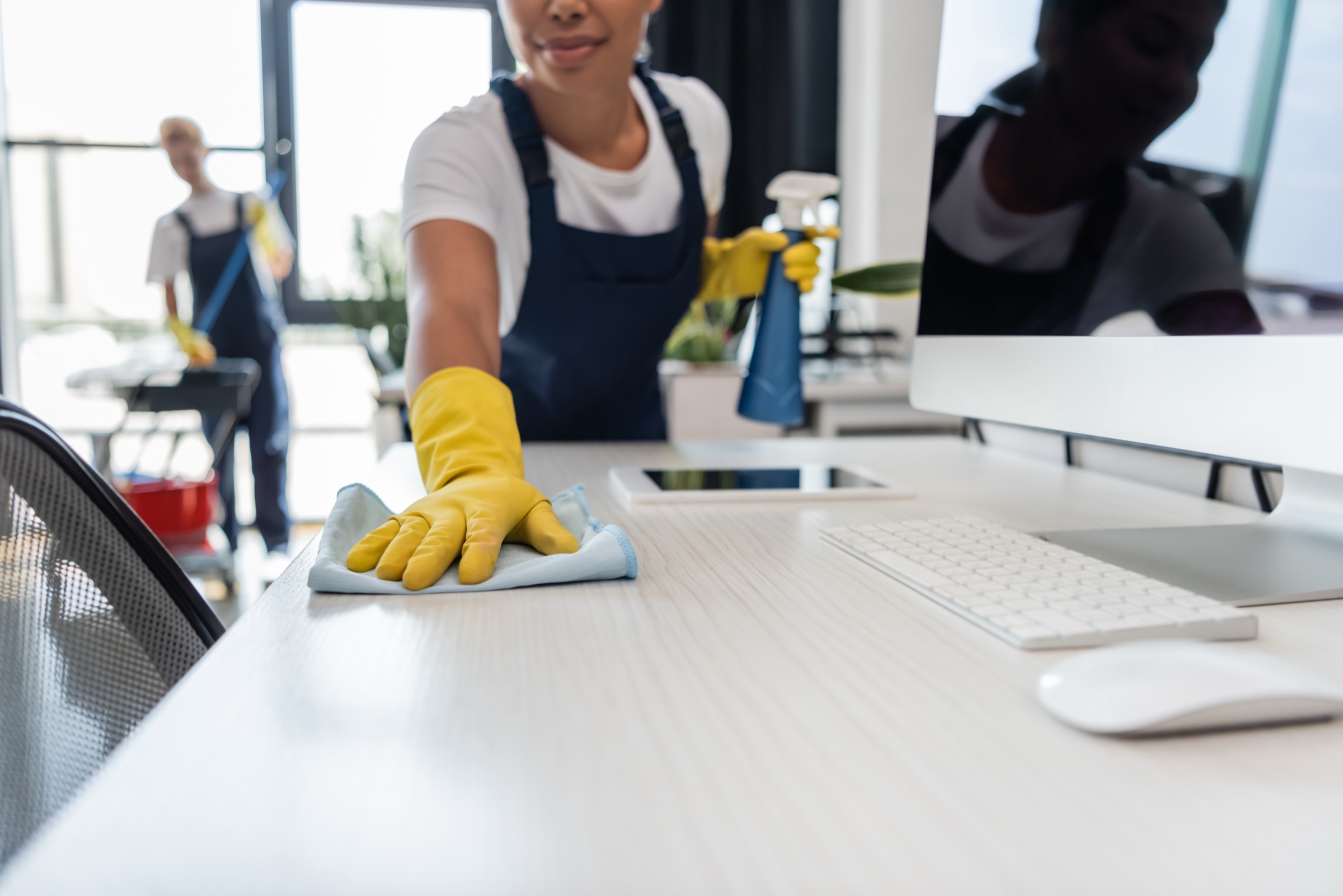 VW Green Cleaning team member servicing an office workspace